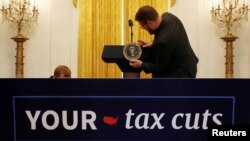 The presidential seal is placed on the lectern before U.S. President Donald Trump delivers remarks celebrating six months since his tax cuts victory at the White House in Washington, June 29, 2018.