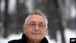 FILE - Czech Oscar-winning film director Jiri Menzel poses for the photographer. in Prague, Czech Republic, Feb. 13, 2013. 