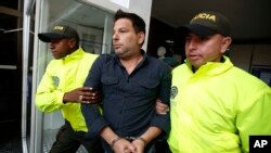 Police escort Cuban suspect Raul Gutierrez to court, where a judge ordered him held without bail on terrorism and conspiracy charges, in Bogota, Colombia, March 15, 2018.