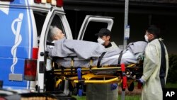 A patient is evacuated from the Magnolia Rehabilitation and Nursing Center in Riverside, Calif., April 8, 2020.