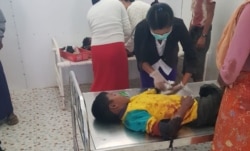FILE - A nurse attends to a boy injured by a blast in Buthidaung township, in Myanmar's Rakhine state, Jan. 7, 2020. (Photo provided to VOA by source who requested not to be identified)
