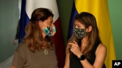 Colombia's Foreign Minister Marta Lucia Ramirez, left, and Panama's Foreign Minister Erika Mouynes, talk during a press conference after a private meeting in Meteti, Darien province, Panama, near the border with Colombia, Aug. 6, 2021.