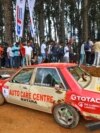 People gather around a car that crashed into the spectators during the Fox Hill Supercross, a motor racing event organized by Sri Lanka's army, in Diyatalawa, Sri Lanka, April 21, 2024. 