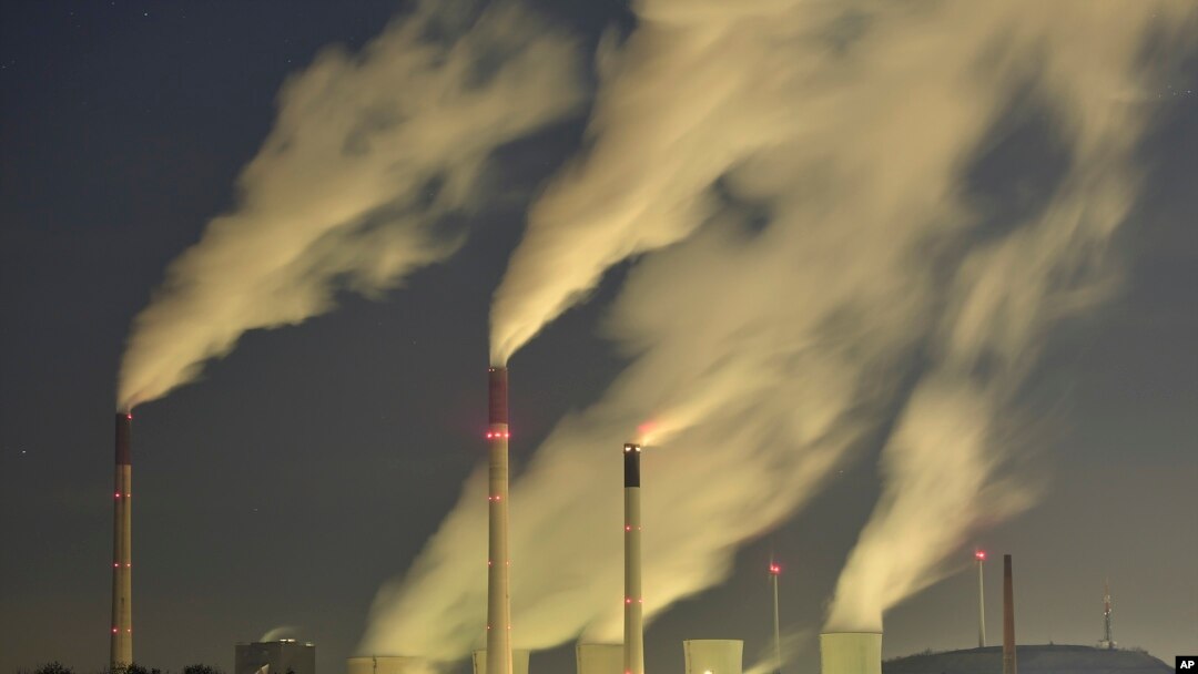 FILE - Smoke streams from the chimneys of a coal-fired power station in Gelsenkirchen, Germany, Nov. 24, 2014.