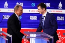 From left, Democratic presidential candidates, former New York City Mayor Mike Bloomberg, and former South Bend Mayor Pete Buttigieg, shake hands on stage at the end of the Democratic presidential primary debate Feb. 25, 2020, in Charleston, S.C.
