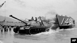 FILE - A U.S. Marine landing craft unloads an M49 on the beach at Da Nang, South Vietnam, April 10, 1965.