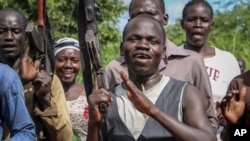 FILE - Opposition soldiers chant "Viva IO", meaning "long live the opposition", during a visit by a ceasefire monitoring team, at an opposition military camp near the town of Nimule in Eastern Equatoria state.