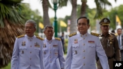 FILE - Thailand Prime Minister Prayuth Chan-ocha, second right, walks to attend a cabinet meeting with aides and at the Government House of Thailand in Bangkok, Thailand, Tuesday, Aug. 27, 2019. 