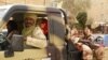 Tuareg fighters from the Movement for the Liberation of Azawad sit in their vehicle, in a market in Timbuktu, Mali, April 14, 2012.