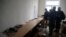 FILE - Belsat journalists examine empty tables after Belarusian police conducted a search and confiscated equipment in the broadcaster's office in capital Minsk, Belarus, March 31, 2017. A similar raid was conducted Tuesday.