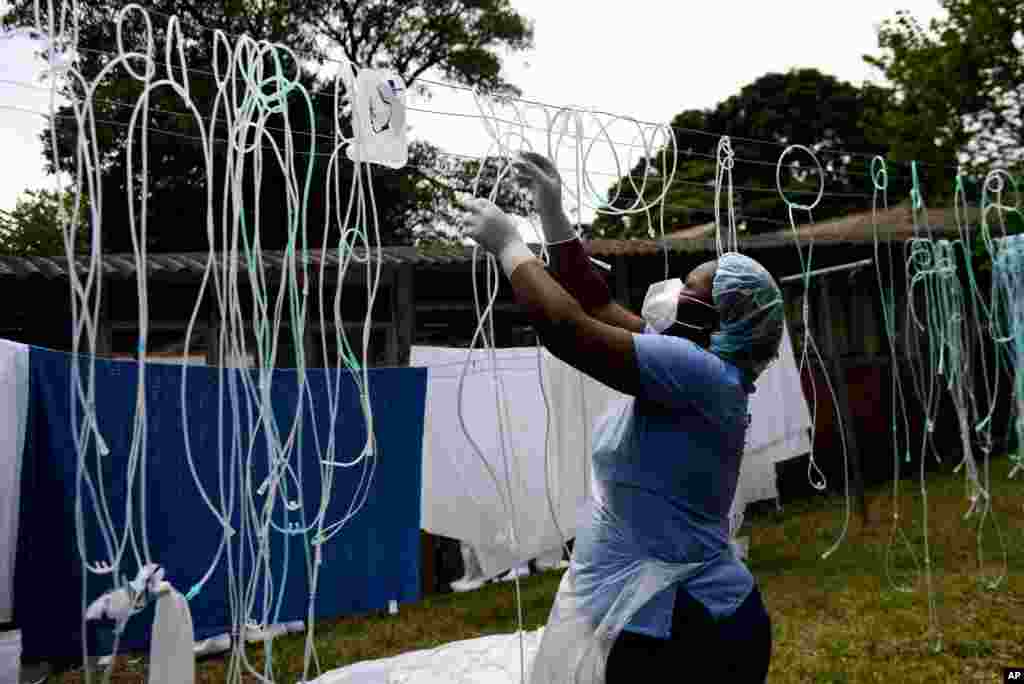 A health worker dries decontaminated nasal prongs and oxygen face masks at Queen Elizabeth Central Hospital in Blantyre, Malawi.