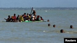 Rohingya refugees arriving on a makeshift boat