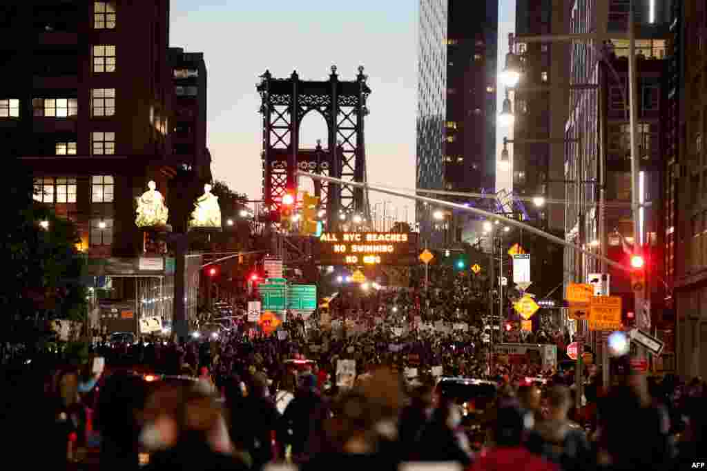 Activists march over the Manhattan bridge during a rally on May 31, 2020 in the Brooklyn borough of New York City.