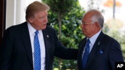 President Donald Trump greets Malaysian Prime Minister Najib Razak at the White House