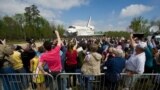 Space shuttle Discovery is rolled toward the transfer ceremony at the Steven F. Udvar-Hazy Center. (NASA/Carla Cioffi)
