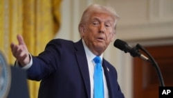 FILE - President Donald Trump speaks during a news conference in the East Room of the White House, Feb. 4, 2025. The Trump administration is pressing federal workers to leave their jobs in an effort to overhaul the federal government.