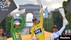 Chris Froome, center, celebrates his overall victory with Peter Sagan of Slovakia, left, and Nairo Quintana of Colombia after the final stage of the 102nd Tour de France in Paris, July 26, 2015. 