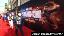 FILE - Fans dressed as Marvel characters attend the premiere of "Shang-Chi and the Legend of the Ten Rings" at the El Capitan Theater in Los Angeles, California, Aug. 16, 2021. (Jordan Strauss/Invision/AP) 