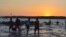 FILE - Fishermen return from a day of fishing nearby in the South China Sea, while others head out for overnight fishing, Masinloc, Philippines, Nov. 8, 2015. (S. Orendain/VOA)