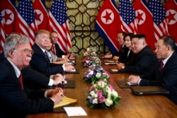 FILE - President Donald Trump speaks during a meeting with North Korean leader Kim Jong Un, in Hanoi, Vietnam, Feb. 28, 2019. At left is then-National Security Adviser John Bolton.