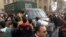 Protesters attack a police vehicle driving by an anti-government protest in Cairo, Feb. 22, 2013.