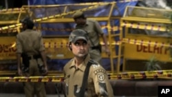 A Delhi police commando stands guard at the site of Wednesday's blast at the Delhi High court in New Delhi, India, September 8, 2011