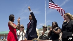 President Barack Obama gives the thumbs-up after signing an Executive Order to help protect military service members from aggressive and deceptive targeting by educational institutions at Fort Stewart, Georgia, April 27, 2012.