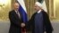 FILE - In this Nov. 1, 2017 file photo released by an official website of the office of the Iranian Presidency, Iran's President Hassan Rouhani, right, shakes hands with Russian President Vladimir Putin, at the Saadabad Palace in Tehran.