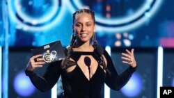 FILE - Alicia Keys presents the award for record of the year at the 60th annual Grammy Awards at Madison Square Garden in New York, Jan. 28, 2018. 