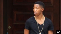 FILE - Grandson Mbuso Mandela, walks out of the main entrance of the home of his grandfather, former president Nelson Mandela in Johannesburg, South Africa, Dec. 7, 2013.