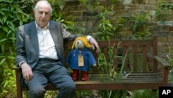British author Michael Bond sits with a Paddington Bear toy during an interview with The Associated Press in London, June 5, 2008. 