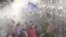In this handout photo released by The International Campaign for Tibet (ICT) on December 7, 2012, paramilitary policemen are seen closing in on Dorje Rinchen's body after his self-immolation, in Xiahe, Gansu province, October 23, 2012.