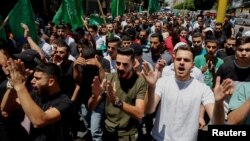 Falasdinawa masu zanga-zanga akan kisan gillar da aka yi wa shugaban Hamas Ismail Haniyeh a Iran, a Hebron