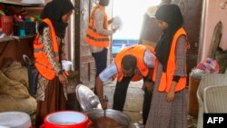 FILE—Volunteers prepare food for internally displaced Muslim devotees for their breaking fast meal during the Islamic holy month of Ramadan in Gedaref on March 13, 2024.