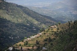 FILE - Houses are in a forest area of the Swat valley of Khyber Pakhtunkhwa in northwest Pakistan, May 18, 2018.