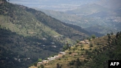 FILE - Houses are seen in a forest area of the Swat valley of Khyber Pakhtunkhwa in northwest Pakistan, May 18, 2018.