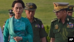 Aung San Suu Kyi, Myanmar's foreign minister and de facto leader (l) walks with senior General Min Aung Hlaing, Myanmar's commander-in-chief (r) in the airport of capital Naypyitaw, Myanmar on May 6, 2016.