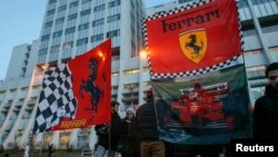 Ferrari flags are seen in front of the CHU Nord hospital emergency unit in Grenoble, French Alps, where retired seven-times Formula One world champion Michael Schumacher is hospitalized after a ski accident, Dec. 31, 2013. 