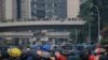 Protesters shield behind umbrellas as they prepare to face off with police in Hong Kong, Sept. 29, 2019. 