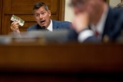 Rep. Sean Duffy holds up a twenty dollar bill as he questions David Marcus, CEO of Facebook's Calibra digital wallet service, as he appears before a House Financial Services Committee hearing on Facebook's proposed cryptocurrency, July 17, 2019.