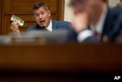 Rep. Sean Duffy holds up a twenty dollar bill as he questions David Marcus, CEO of Facebook's Calibra digital wallet service, as he appears before a House Financial Services Committee hearing on Facebook's proposed cryptocurrency, July 17, 2019.