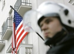 FILE - A Serbian officer protects the U.S. Embassy in Belgrade.