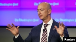 FILE - Amazon.com founder Jeff Bezos, who is also owner of The Washington Post, delivers remarks at the grand opening of the Post newsroom, Jan. 28, 2016. 