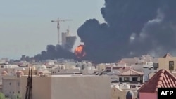 This screen grab taken from UGC video footage posted on social media on July 18, 2026, shows a plume of black smoke and flames billowing over the town of Mangaf, south of Kuwait City.