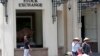 FILE- People walk by the Hanoi Stock Exchange in Hanoi, Vietnam on Sept. 10, 2012.