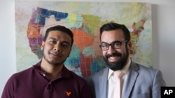 In this Jan. 6, 2020, photo, Michael Navas Gomez, left, poses with his attorney, Joshua Greer in Los Angeles. Navas Gomez, who was detained in a remote detention facility in Louisiana, was lucky to have a lawyer who helped him. 