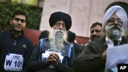 Centenarian Fauja Singh, center, takes part in a running event in Amritsar, India, Sunday, Jan. 22, 2012. 
