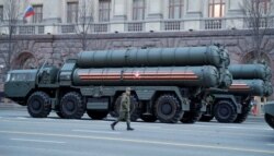 FILE - A Russian serviceman walks past S-400 missile defense systems in central Moscow, April 29, 2019.
