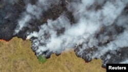 FILE: Billows of smoke rise over a deforested plot of the Amazon jungle in Porto Velho, Rondonia State, Brazil, Aug. 24, 2019.