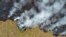 FILE: Billows of smoke rise over a deforested plot of the Amazon jungle in Porto Velho, Rondonia State, Brazil, Aug. 24, 2019.